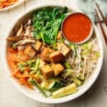 Bowl of Vegan Bibimbap with chopsticks on the side.