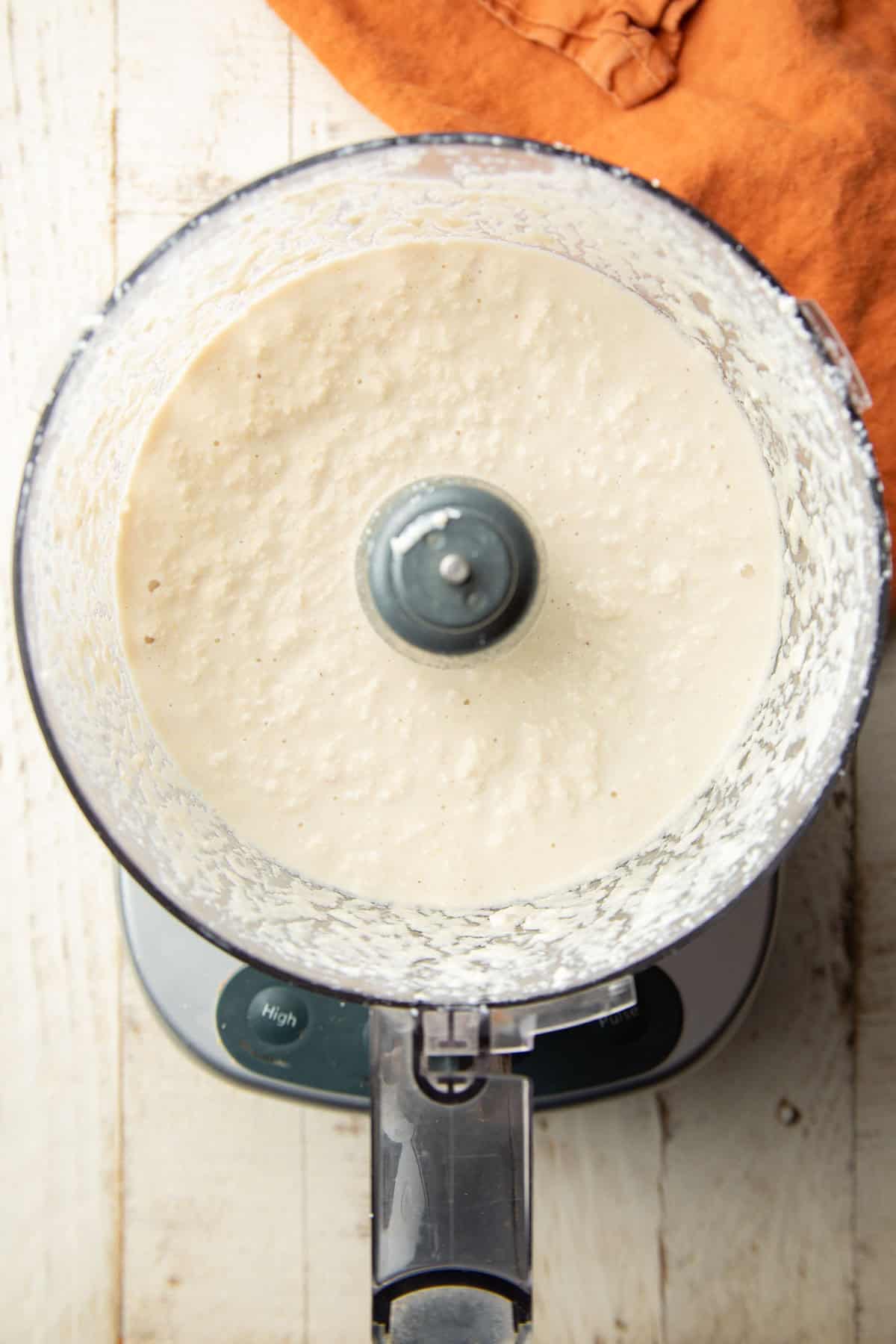 Homemade vegan ricotta sauce in a food processor bowl.