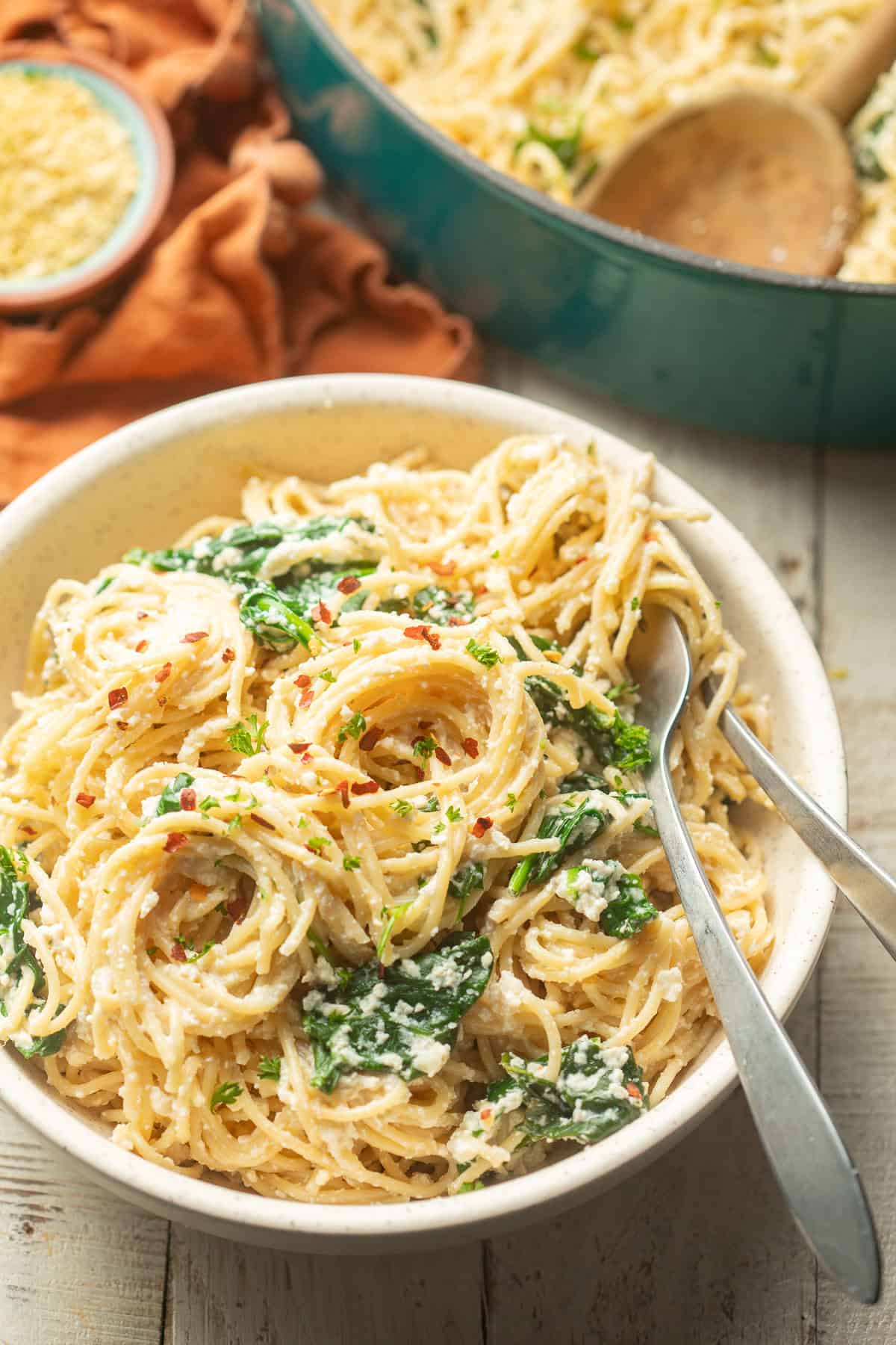 Bowl of Vegan Lemon Ricotta Pasta with a pot in the background.