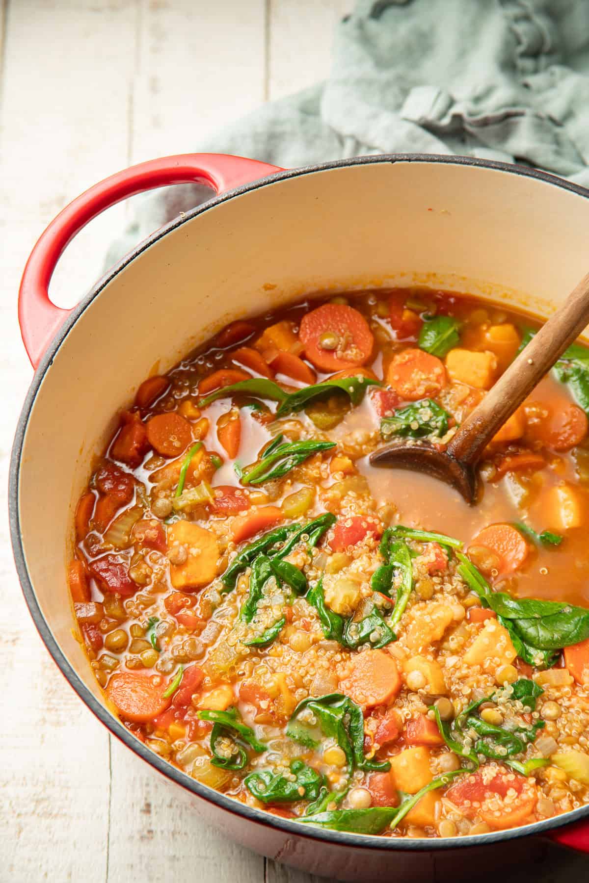 Pot of Quinoa Soup with a wooden spoon.