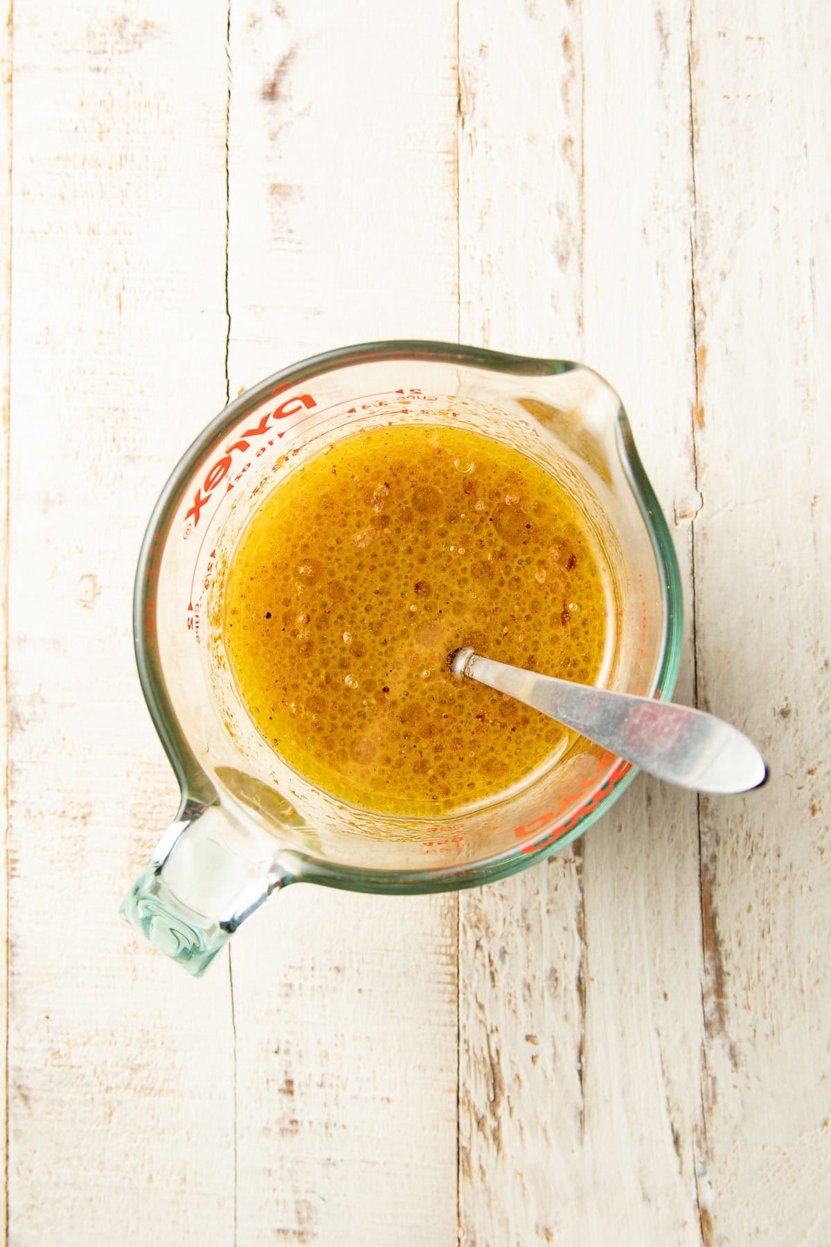 Wet ingredients for Vegan Chocolate Olive Oil Cake in a liquid measuring cup.