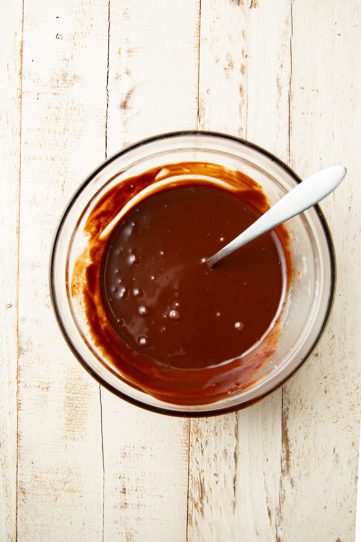 Vegan chocolate ganache in a bowl with spoon.