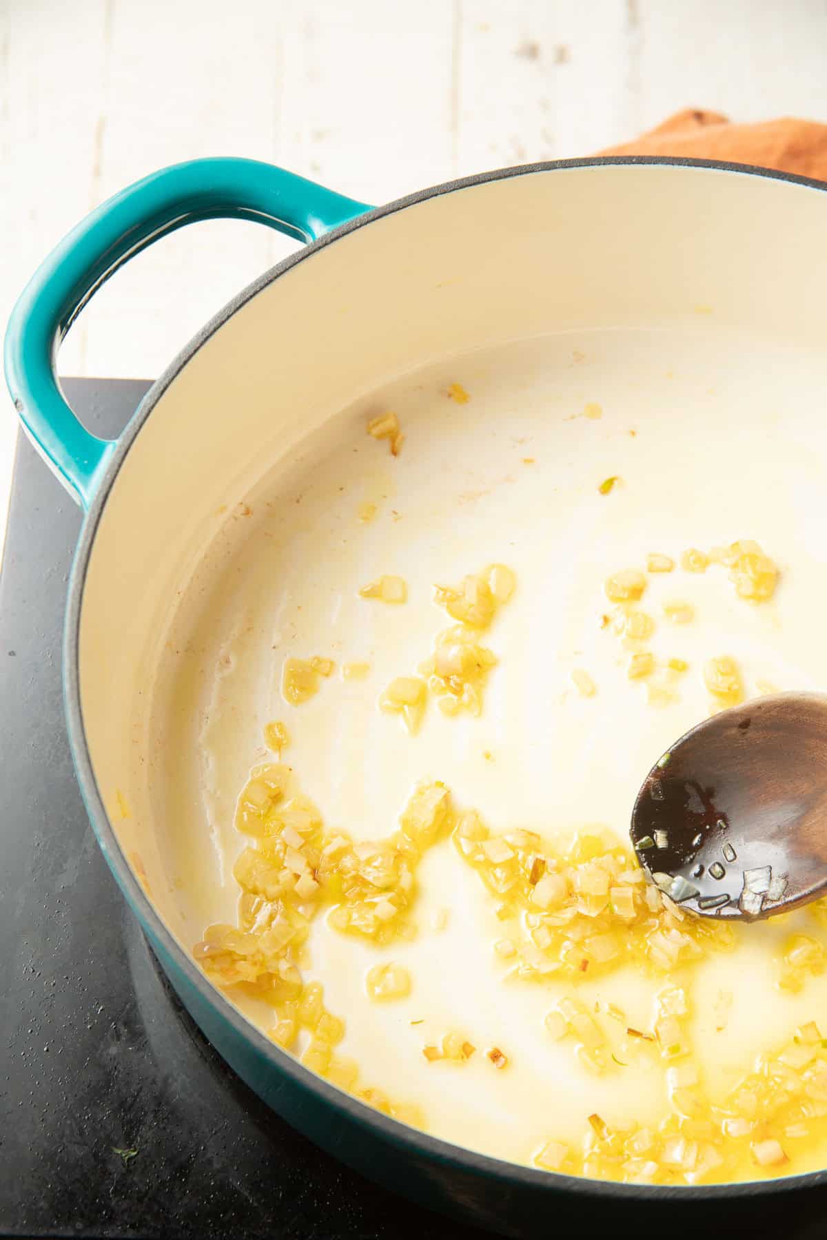 Minced shallots cooking in olive oil.