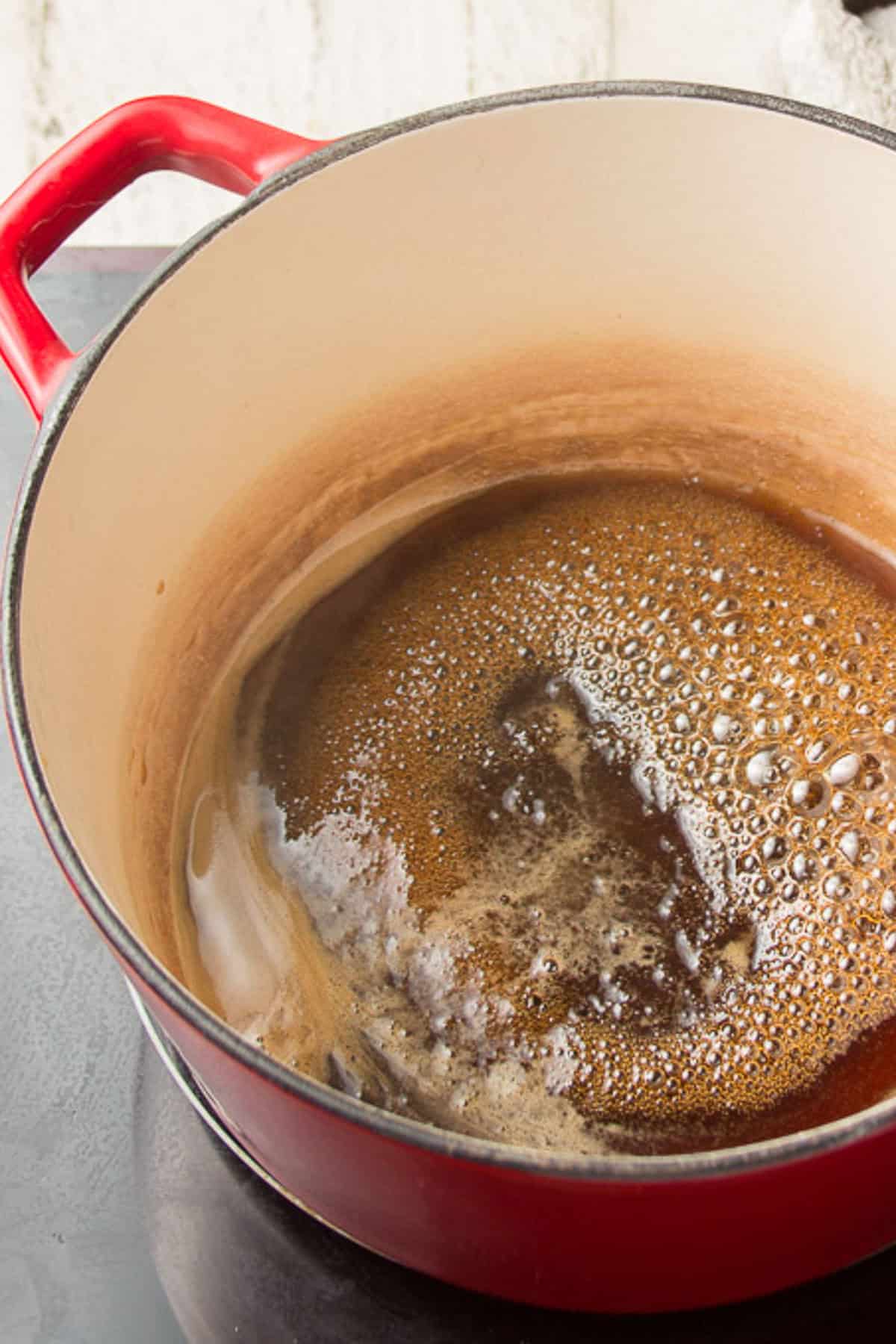 Brown sugar and water simmering in a pot.
