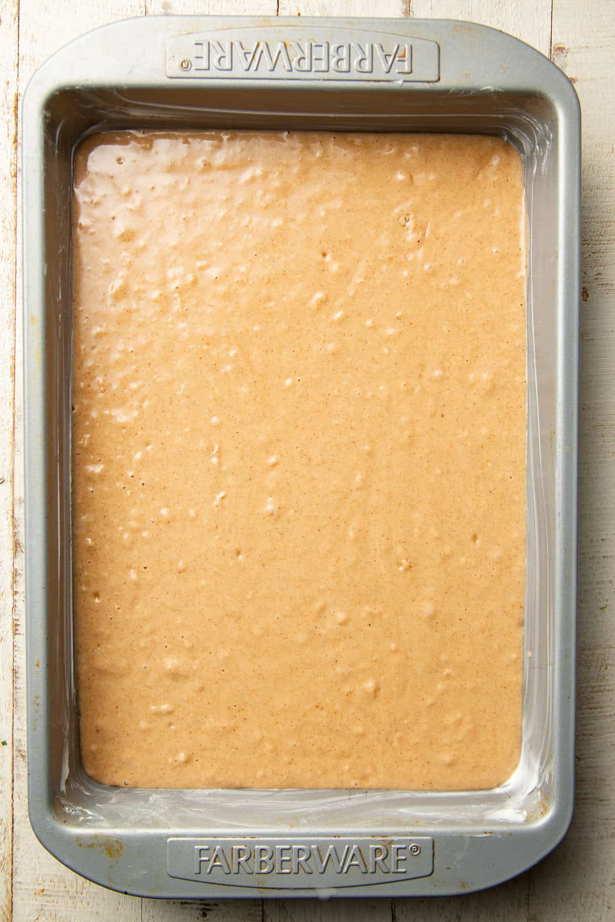 Cake batter in a rectangular cake pan.