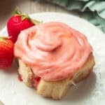 Vegan Strawberry Roll on a plate with fresh strawberries.