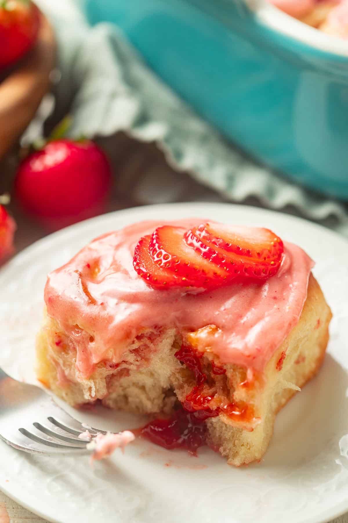 Vegan Strawberry Roll on a plate with a bite taken out.
