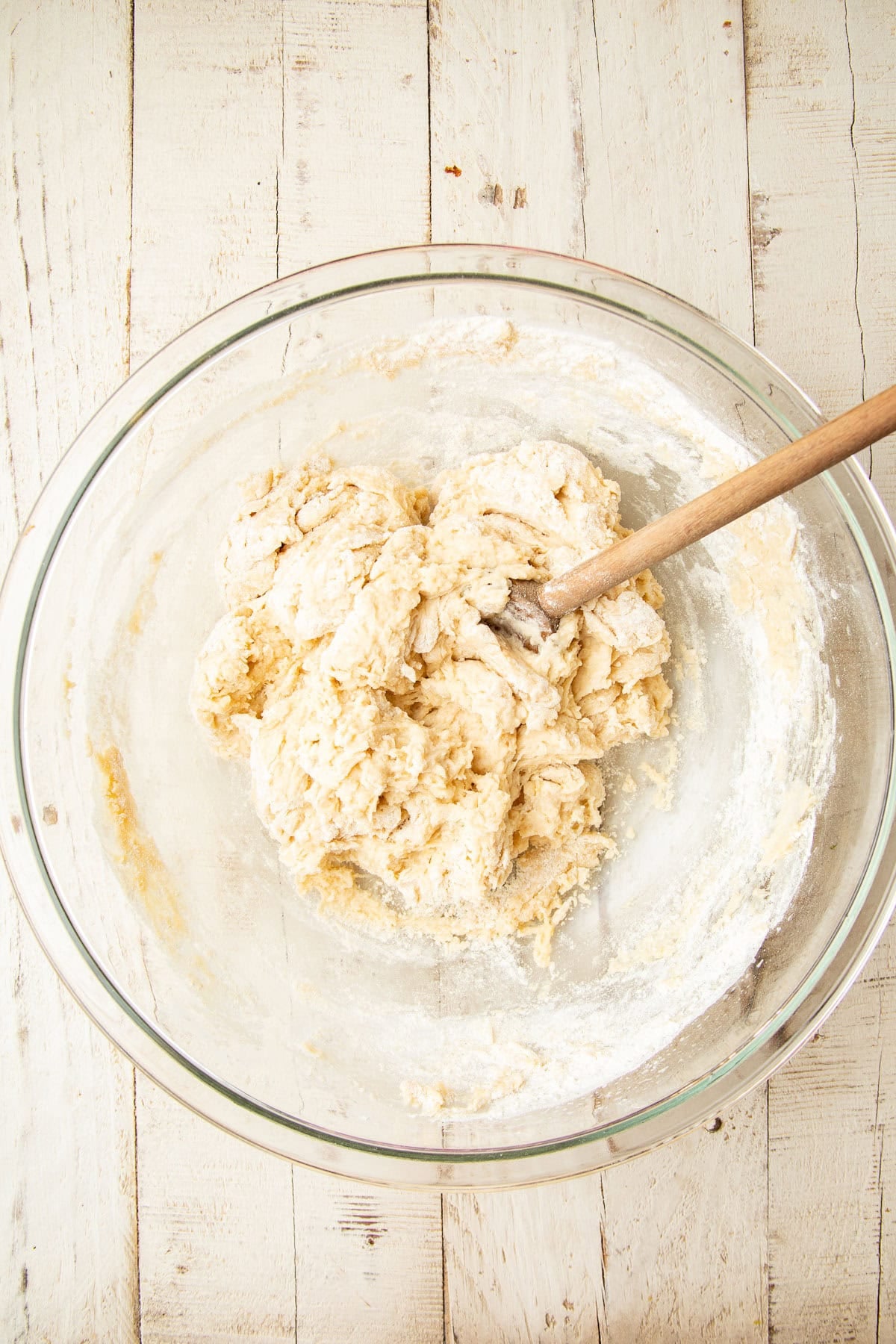 Dough in a mixing bowl with wooden spoon.