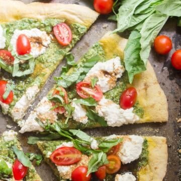 Vegan Caprese Pizza slices on a baking sheet.