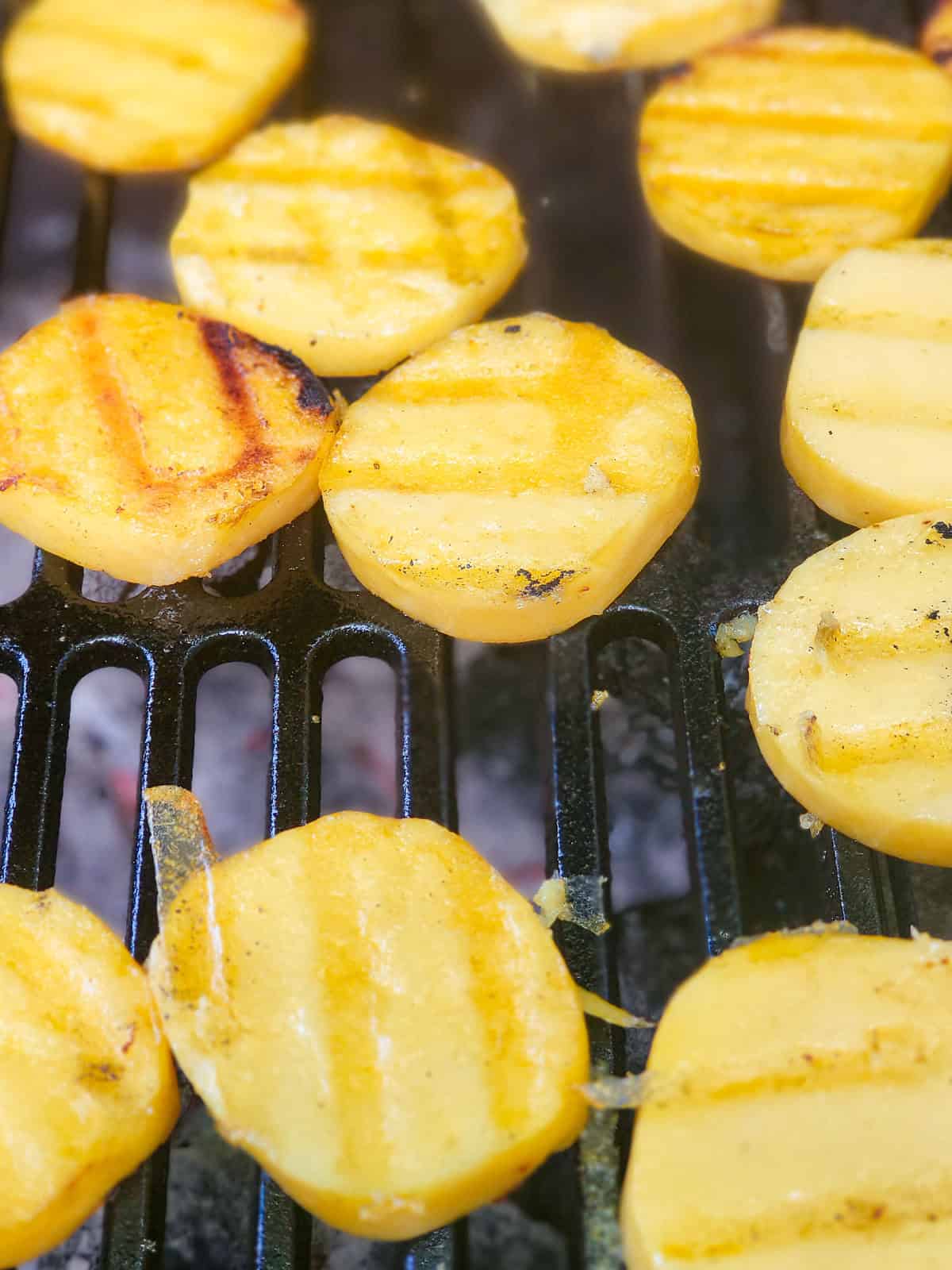 Polenta slices cooking on the grill.