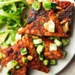Grilled tempeh triangles topped with avocado cucumber relish and peanuts.