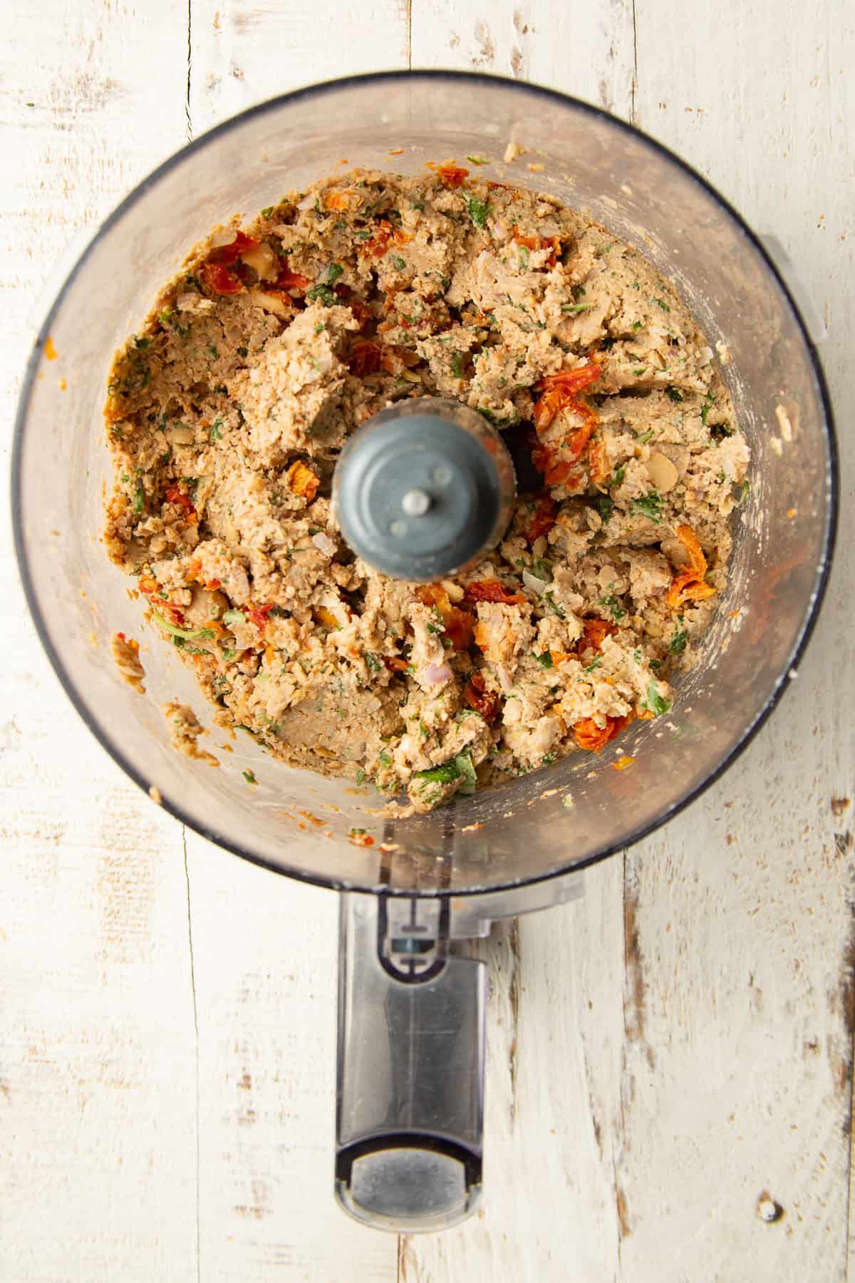Blended ingredients for Marry Me Chickpea Burgers in a food processor bowl.