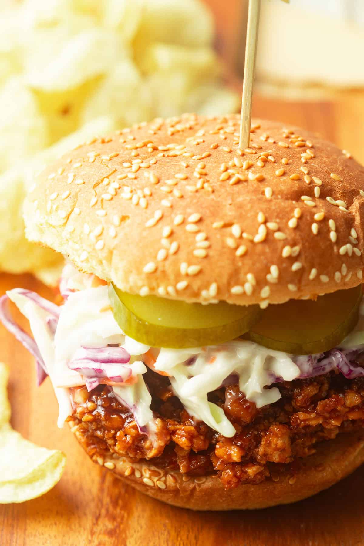 Shredded Tofu Barbecue Sandwich with potato chips in the background.