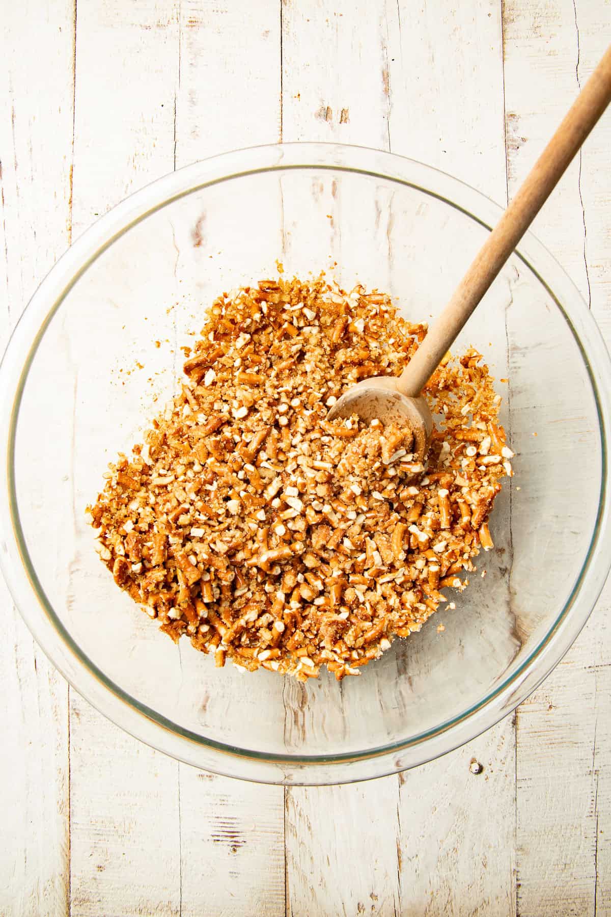 Bowl of crushed pretzels mixed with vegan butter and sugar.