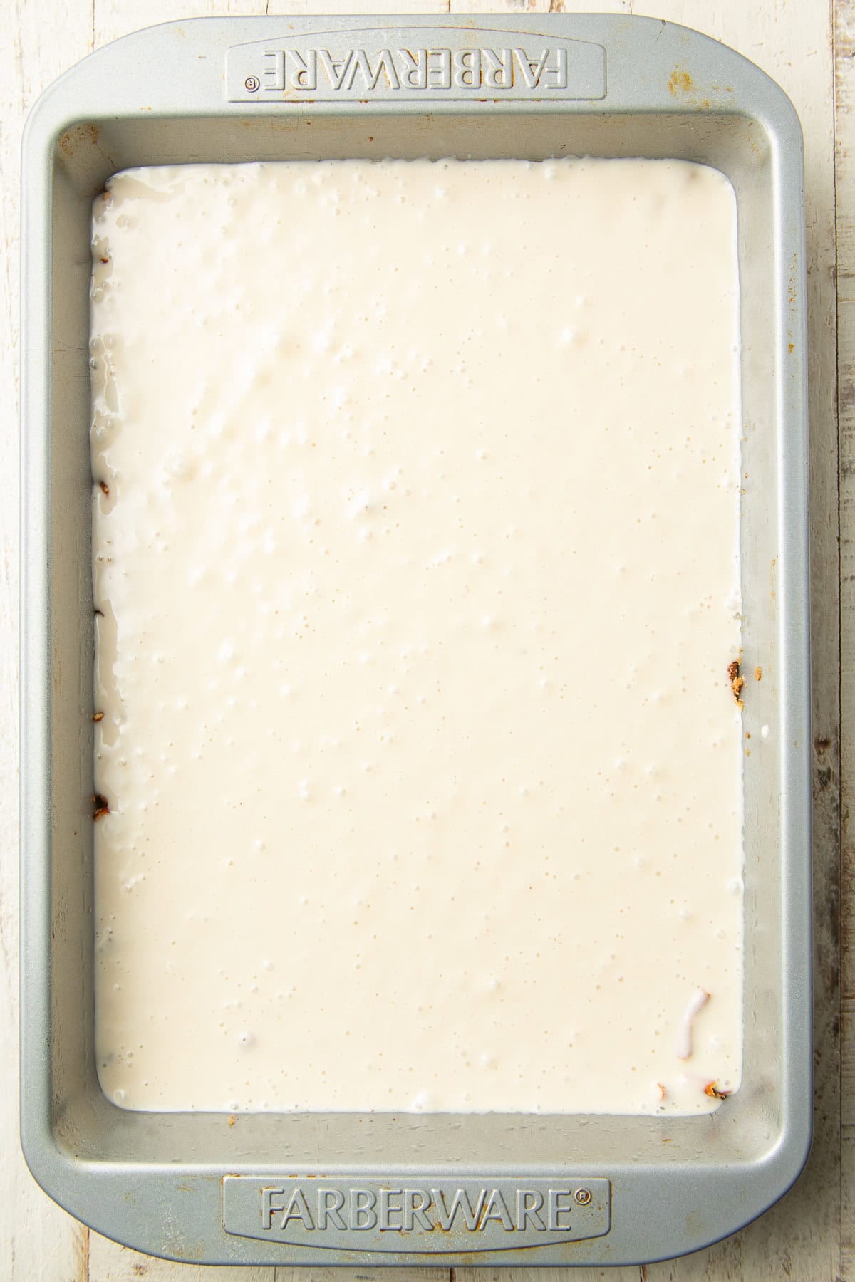 Baking dish with creamy filling layer over a pretzel crust.