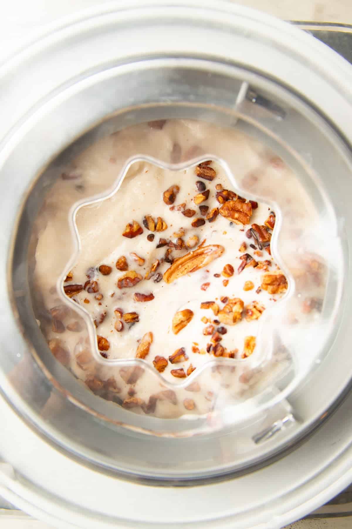 Vegan Butter Pecan Ice Cream churning in an ice cream maker.