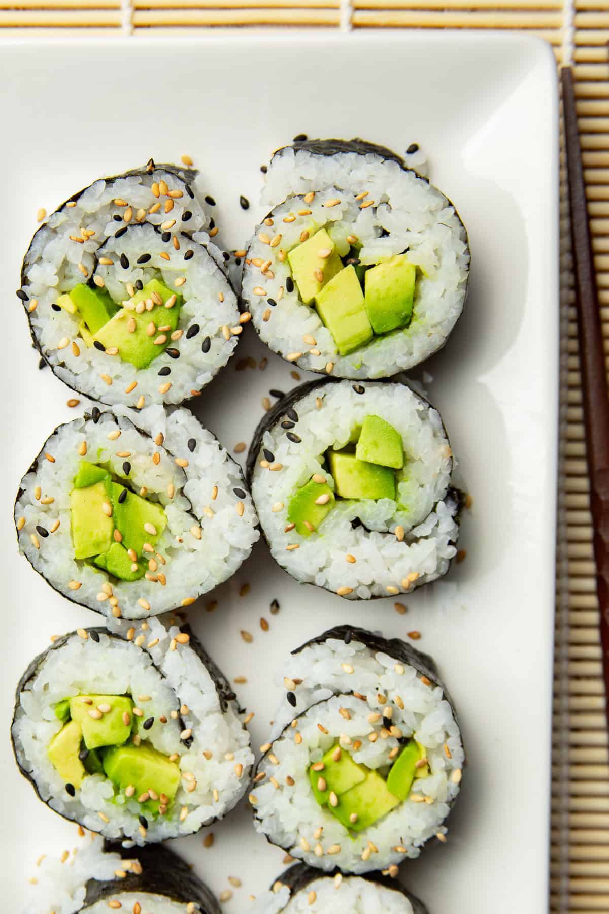 Avocado Sushi pieces on a rectangular dish.