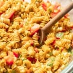 Bowl of Street Corn Pasta Salad with wooden spoon.