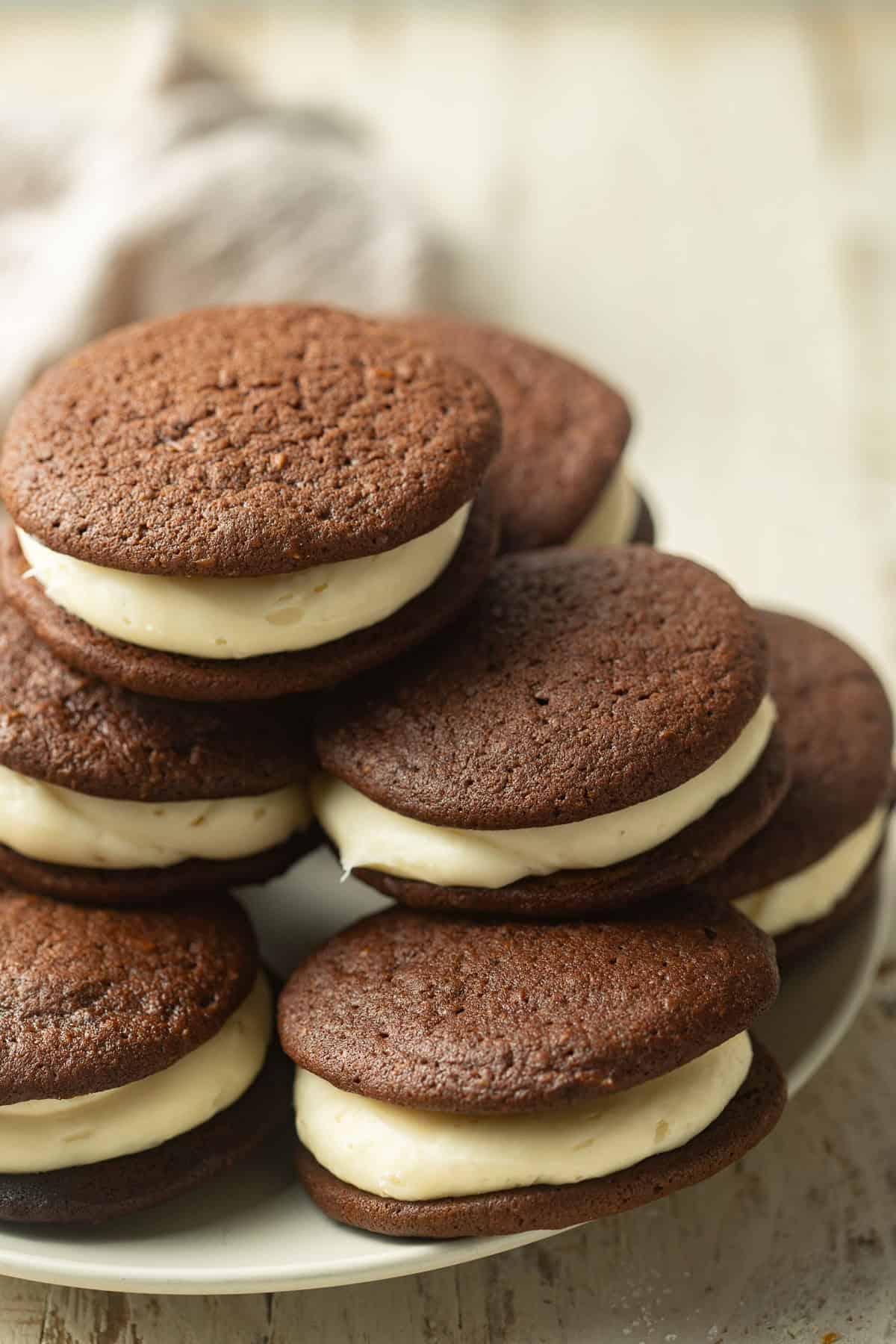 Vegan Whoopie Pies stacked in a pyramid on a plate.
