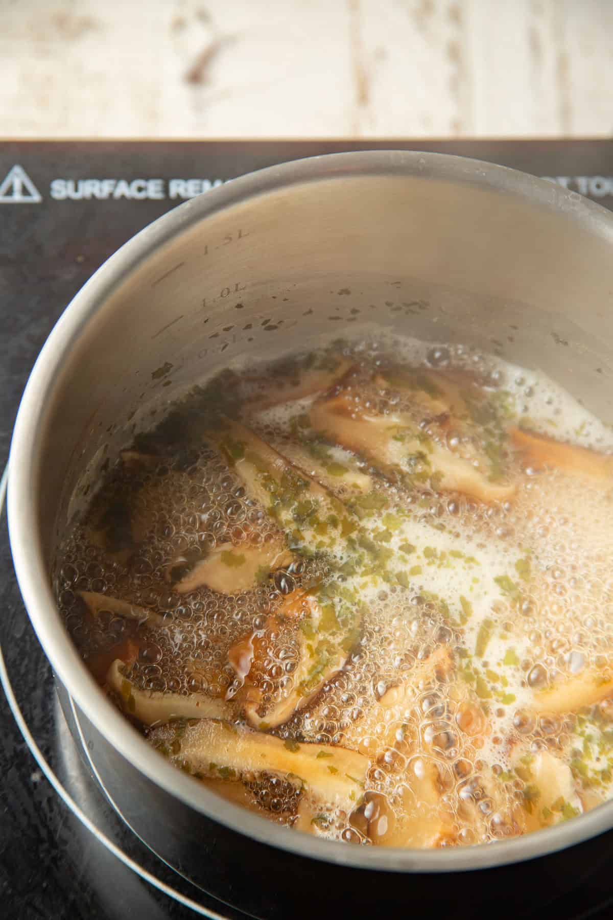 Vegan dashi simmering in a pot.
