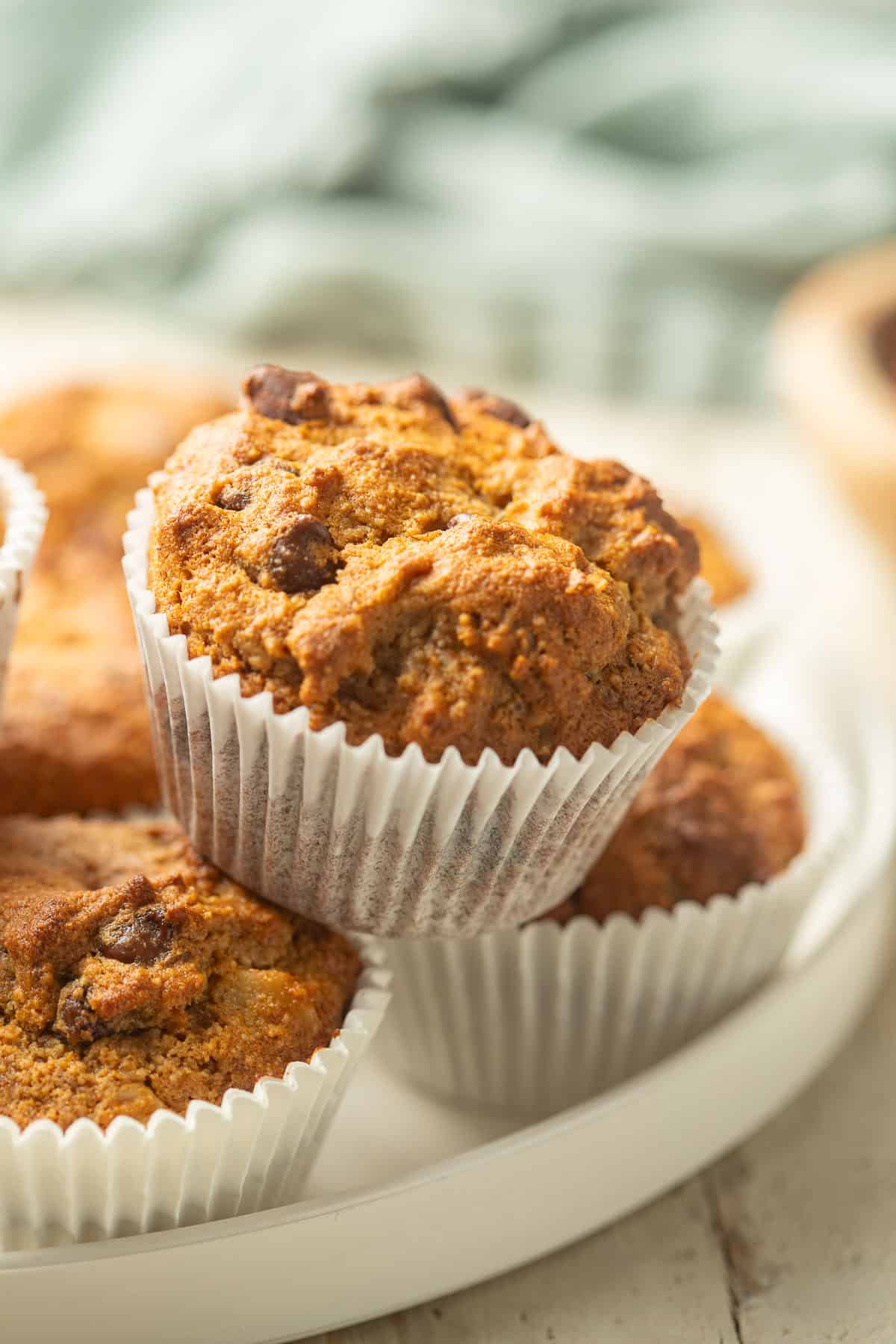 Almond Flour Banana Muffins stacked on a plate.