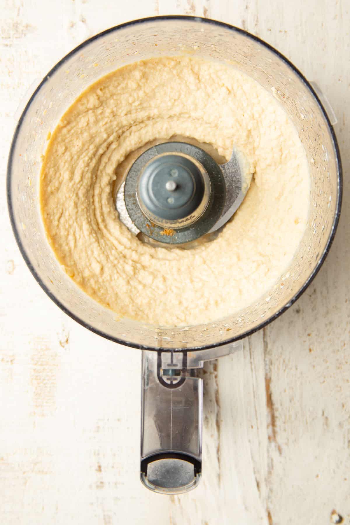 Hummus in a food processor bowl.