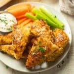 Plate of Lemon Pepper Tofu Wings, veggie sticks, and ranch dressing.