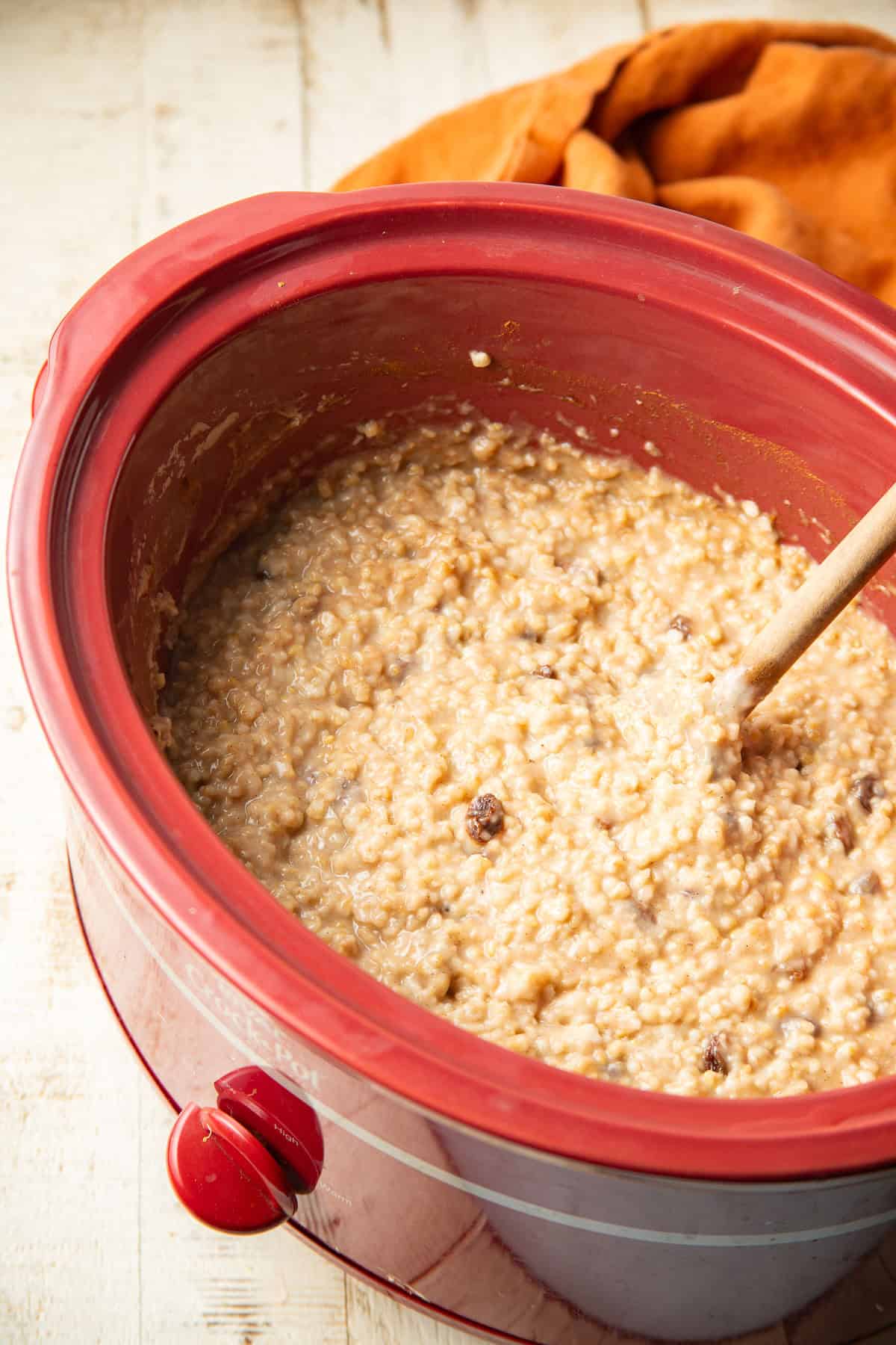 Slow cooker filled with cinnamon raisin oatmeal.