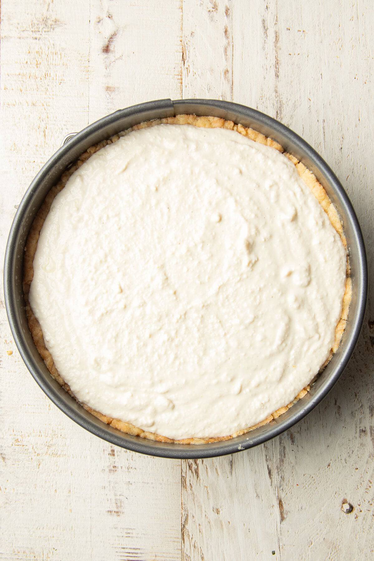 Unbaked Vegan Ricotta Cheesecake in a springform pan.