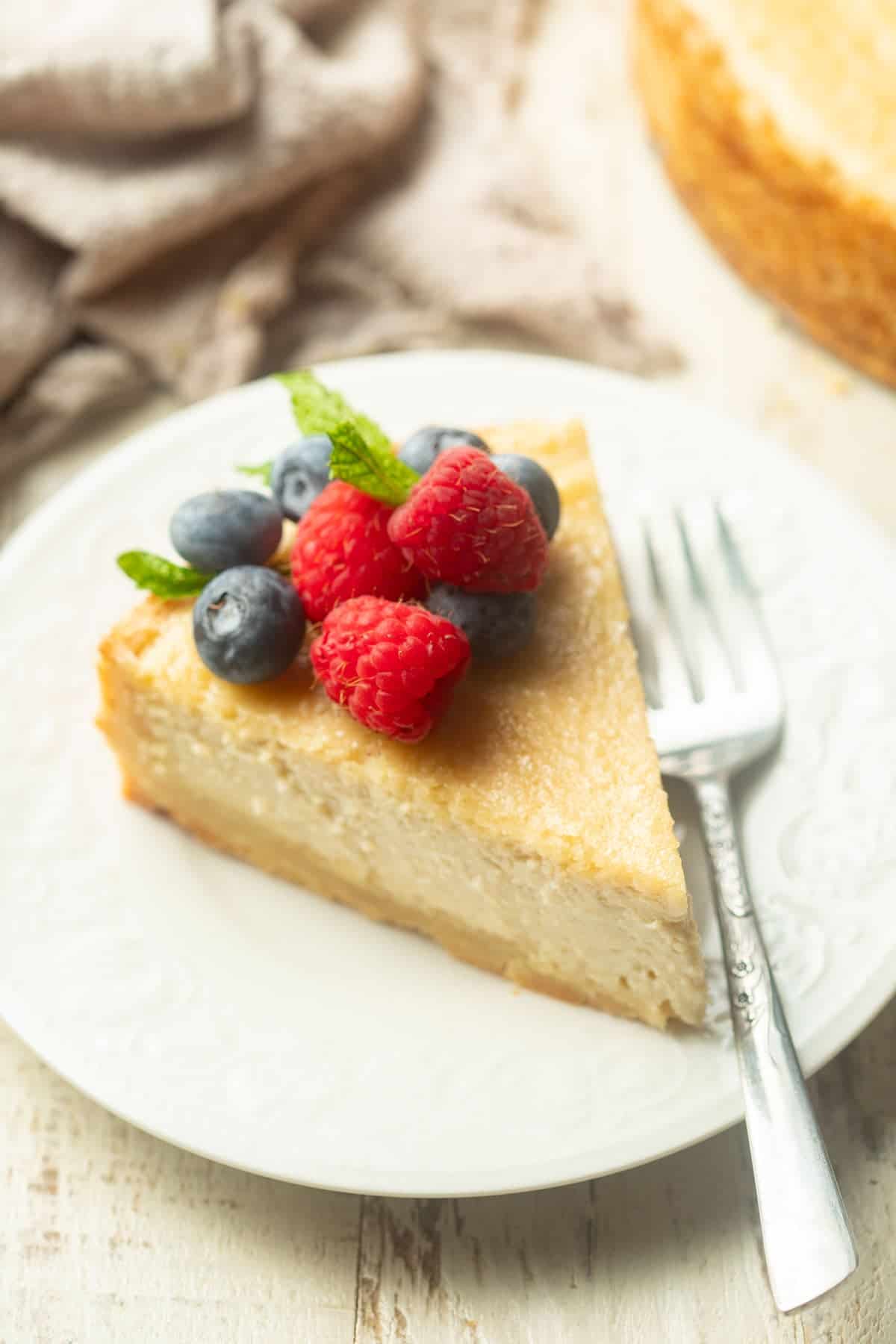 Slice of Vegan Ricotta Cheesecake on a plate with fork.