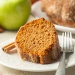 Slice of Apple Cider Doughnut Cake on a plate with fork.
