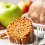 Slice of Apple Cider Doughnut Cake on a plate with fork.
