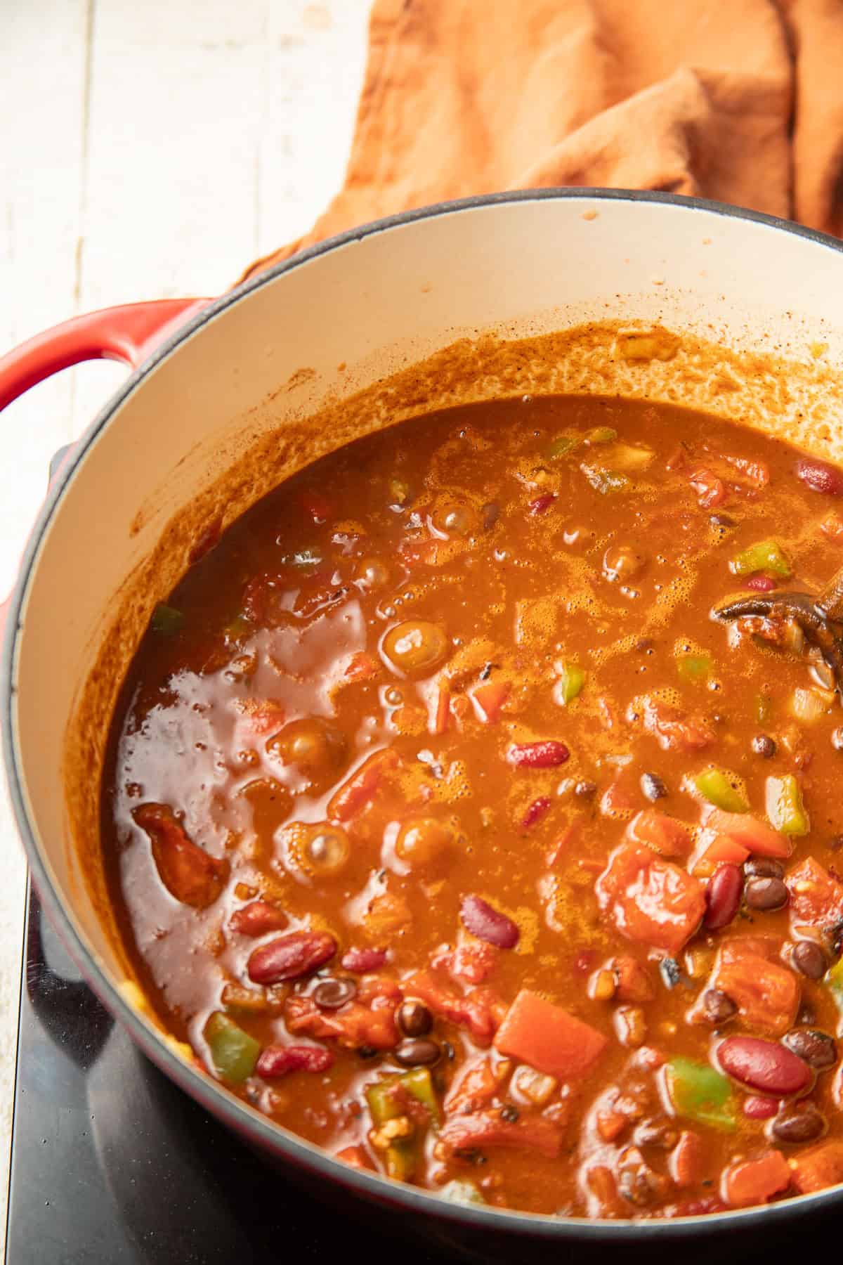 Chili simmering in a pot on the stove.