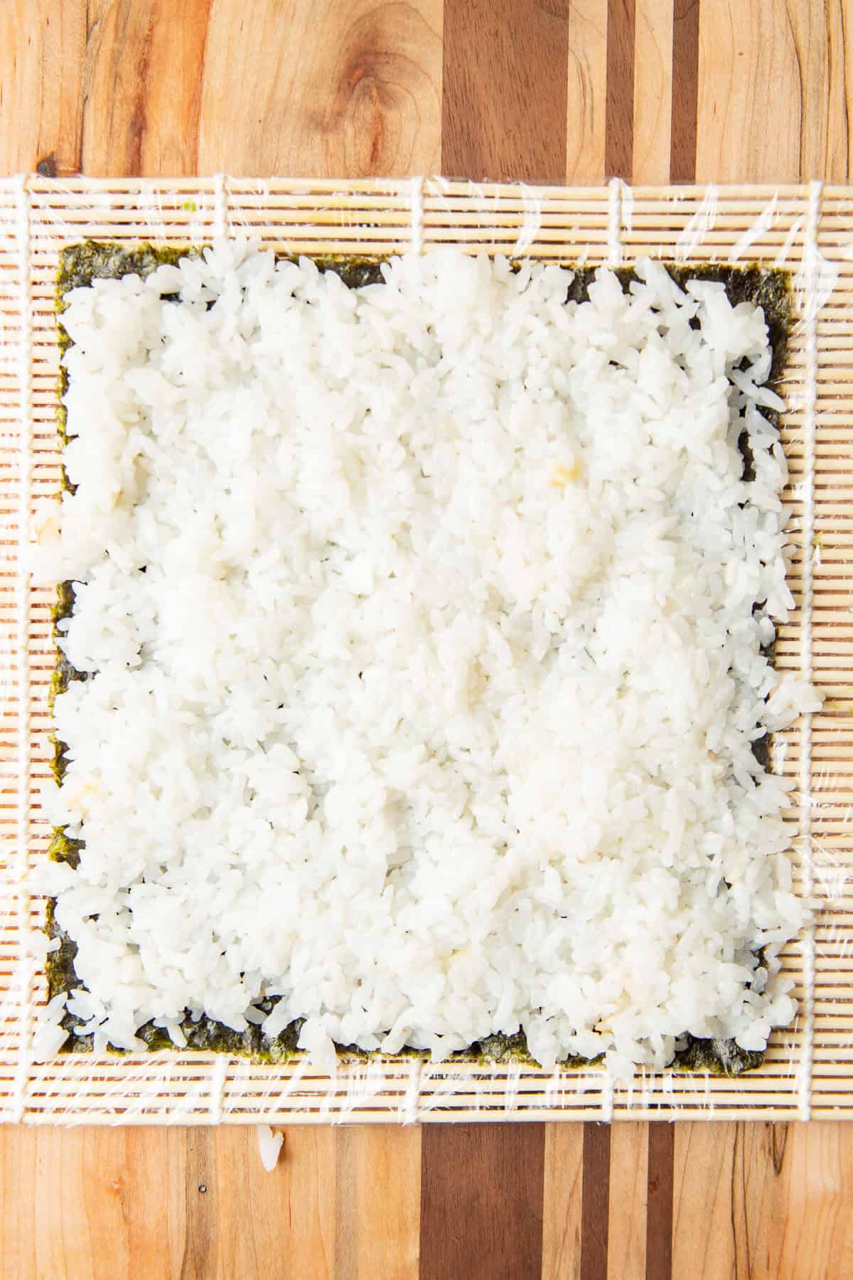Sushi rice over a sheet of nori.