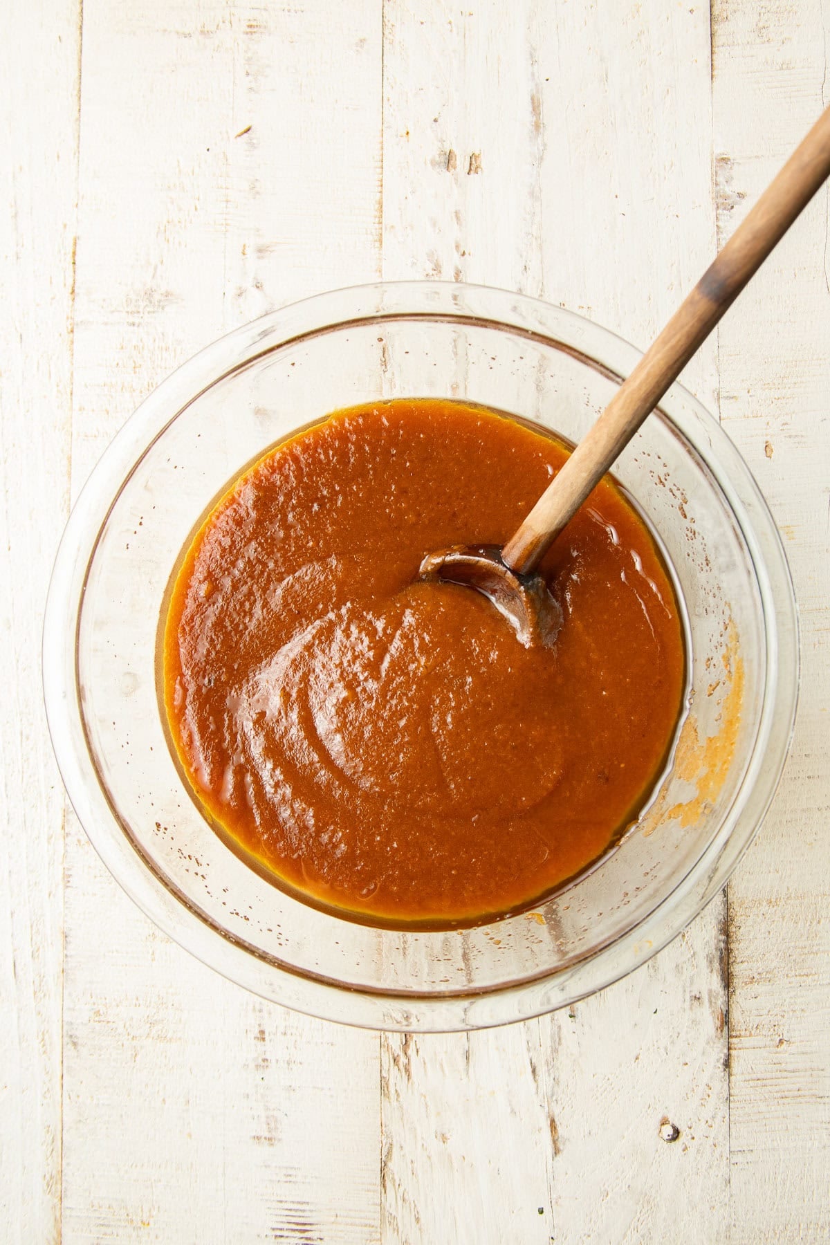 Wet ingredients for Vegan Pumpkin Whoopie Pies in a bowl with spoon.