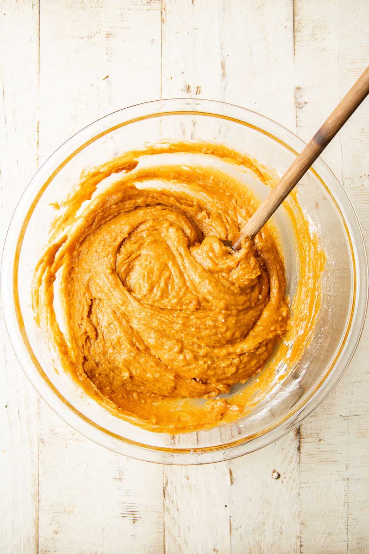 Vegan Pumpkin Whoopie Pie batter in a mixing bowl with spoon.
