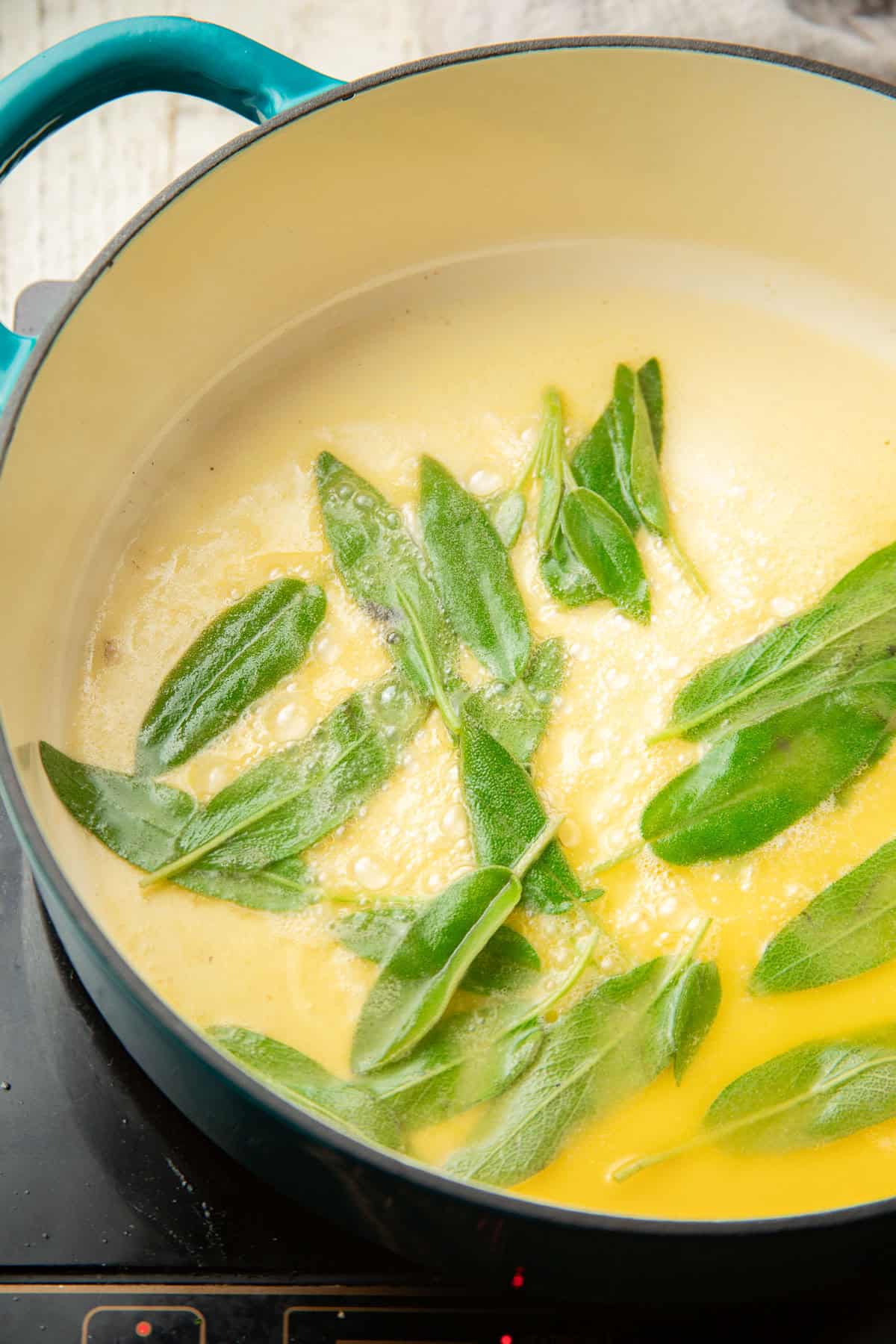 Sage leaves frying in vegan butter.