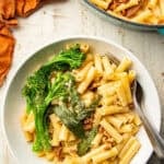White wooden surface set with pot and bowl of Vegan Brown Butter Pasta.