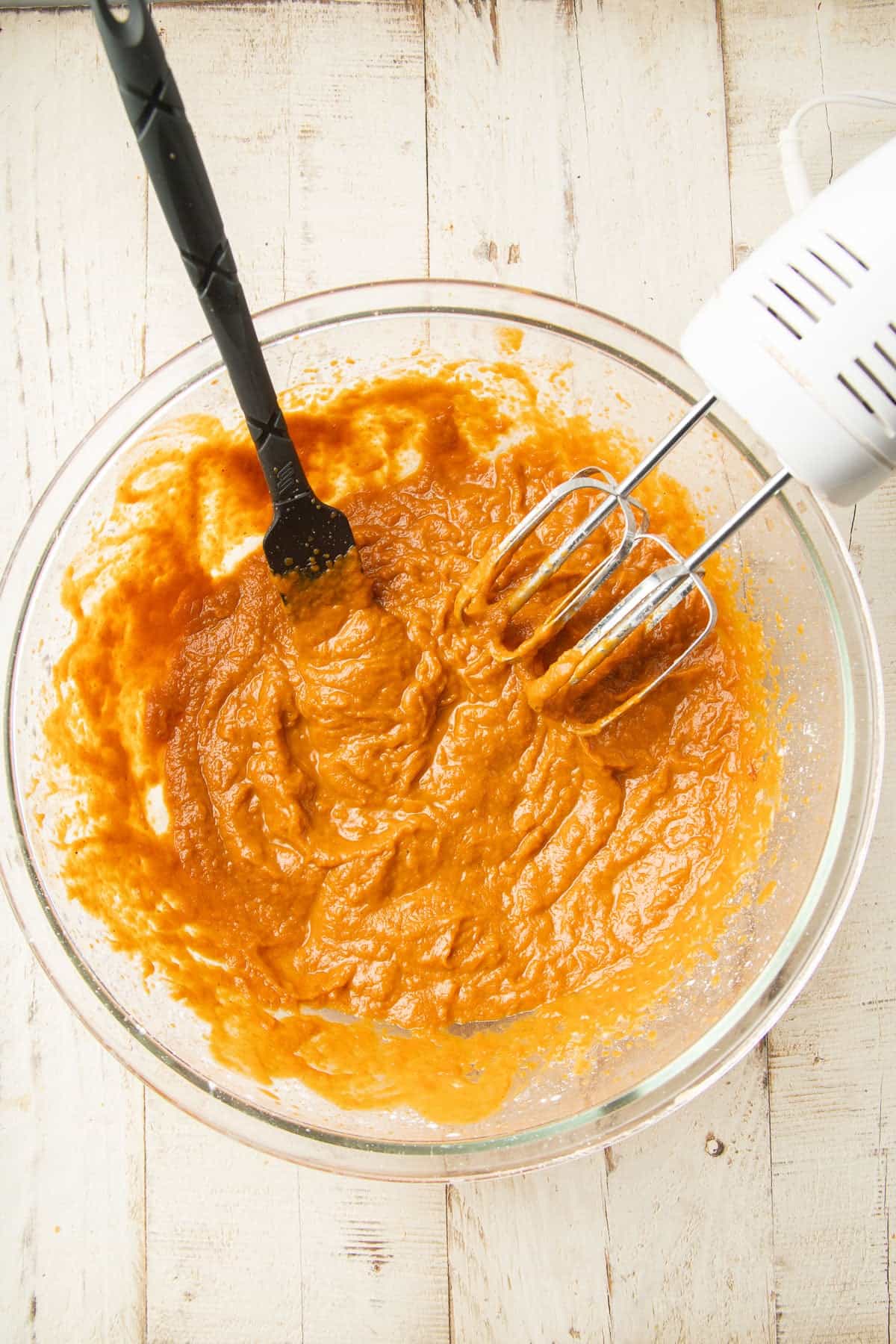 Pumpkin Pie Bar batter in a mixing bowl with electric mixer.