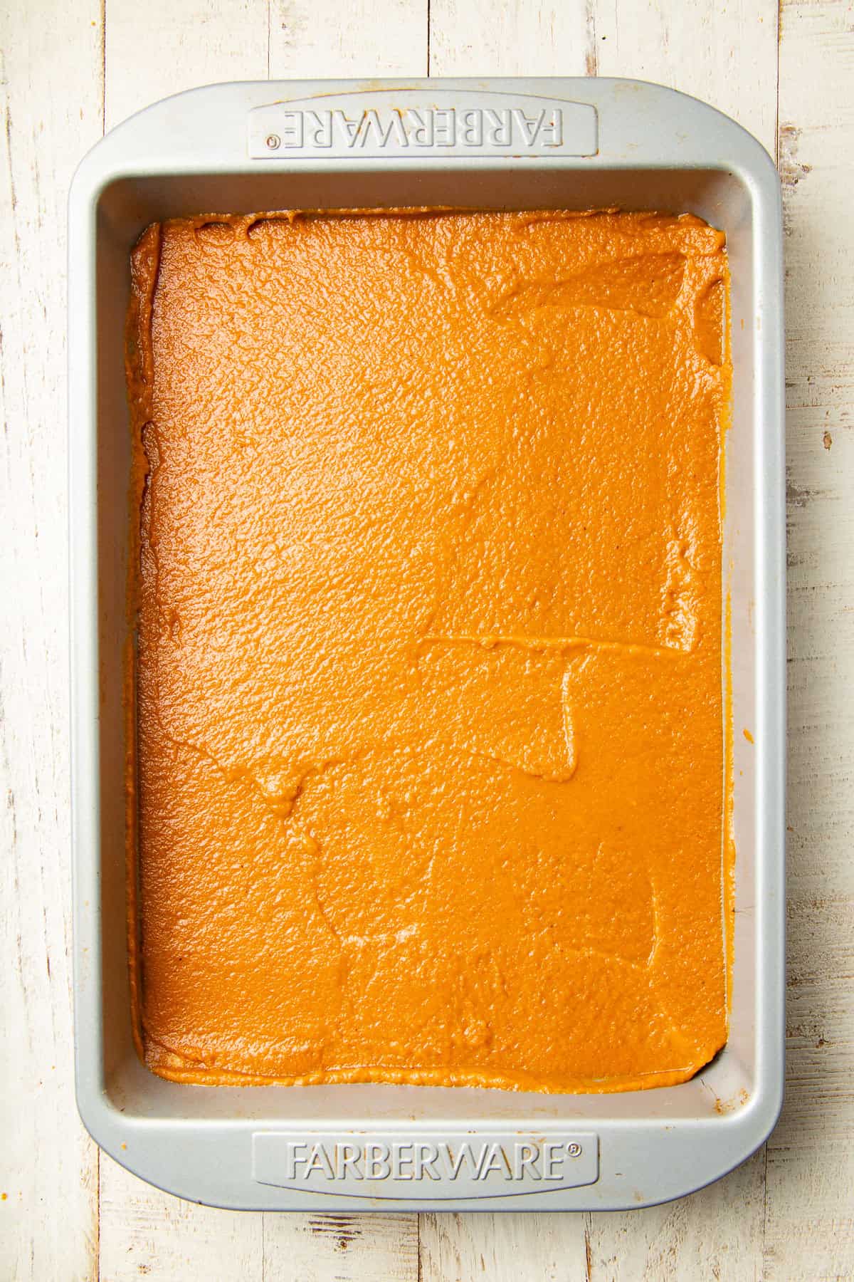 Untopped, unbaked Pumpkin Pie Bars in a baking pan.