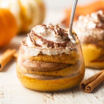 Vegan Pumpkin Tiramisu parfait with pumpkins in the background.